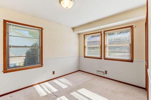 Inviting second bedroom on the main level, highlighted by attractive windows that create a warm, sun-filled feel.