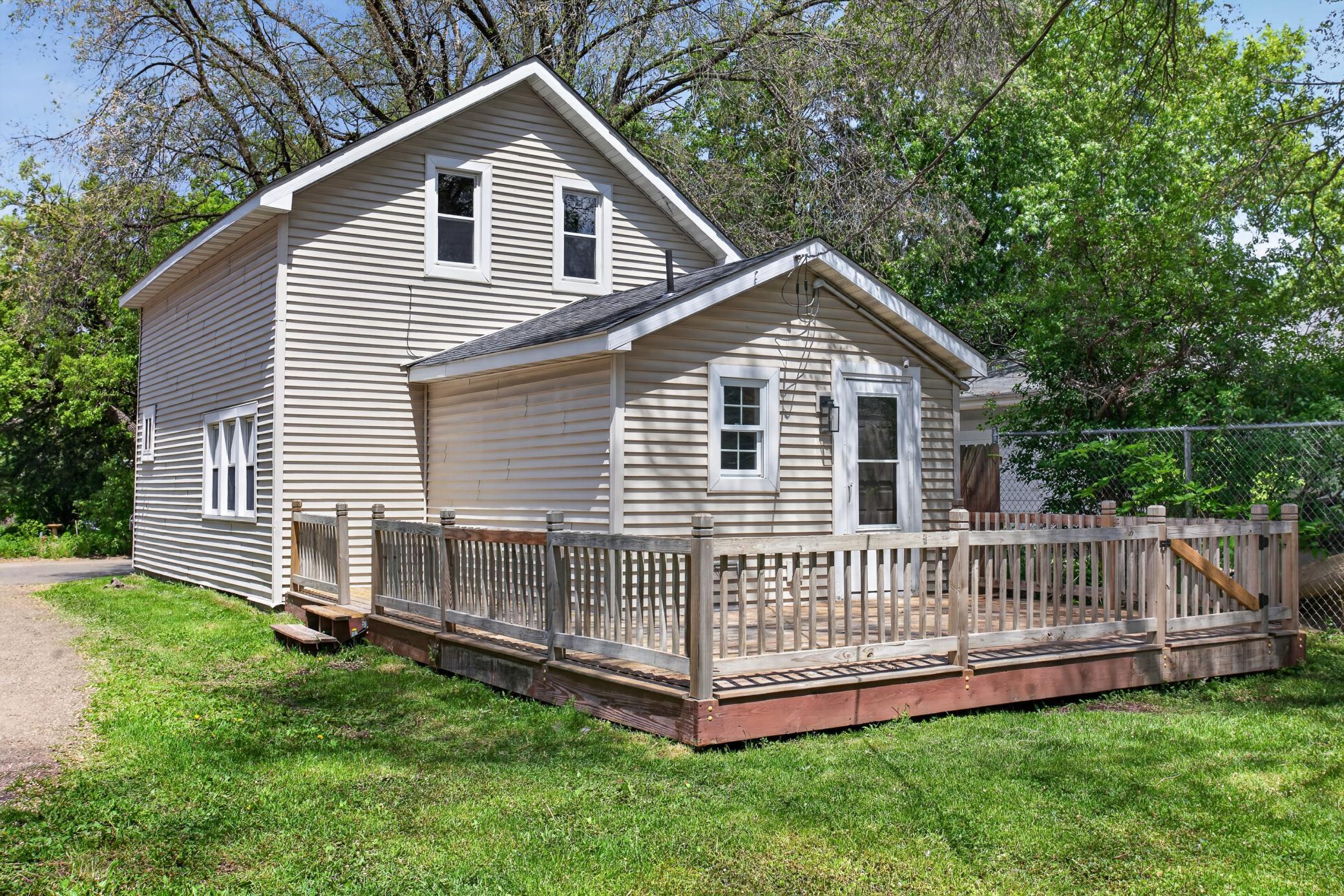 Back of home with extensive deck