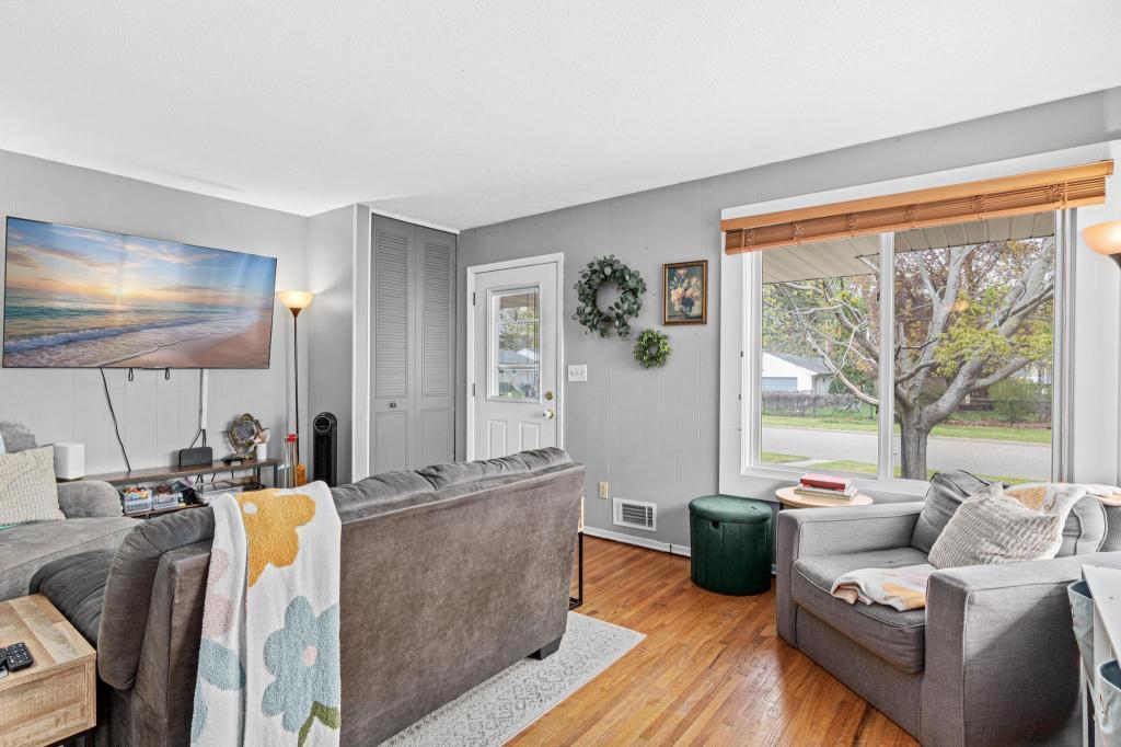 Bright and inviting living room filled with natural light and comfortable living space.