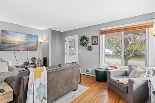 Bright and inviting living room filled with natural light and comfortable living space.
