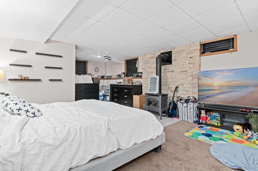 Finished lower level is a great place to watch a movie or your favorite show. Fireplace add warmth and appeal. 3/4 bathroom is located on the back left of the room.