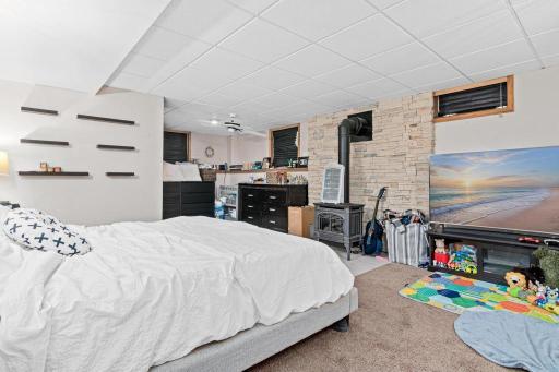 Finished lower level is a great place to watch a movie or your favorite show. Fireplace add warmth and appeal. 3/4 bathroom is located on the back left of the room.