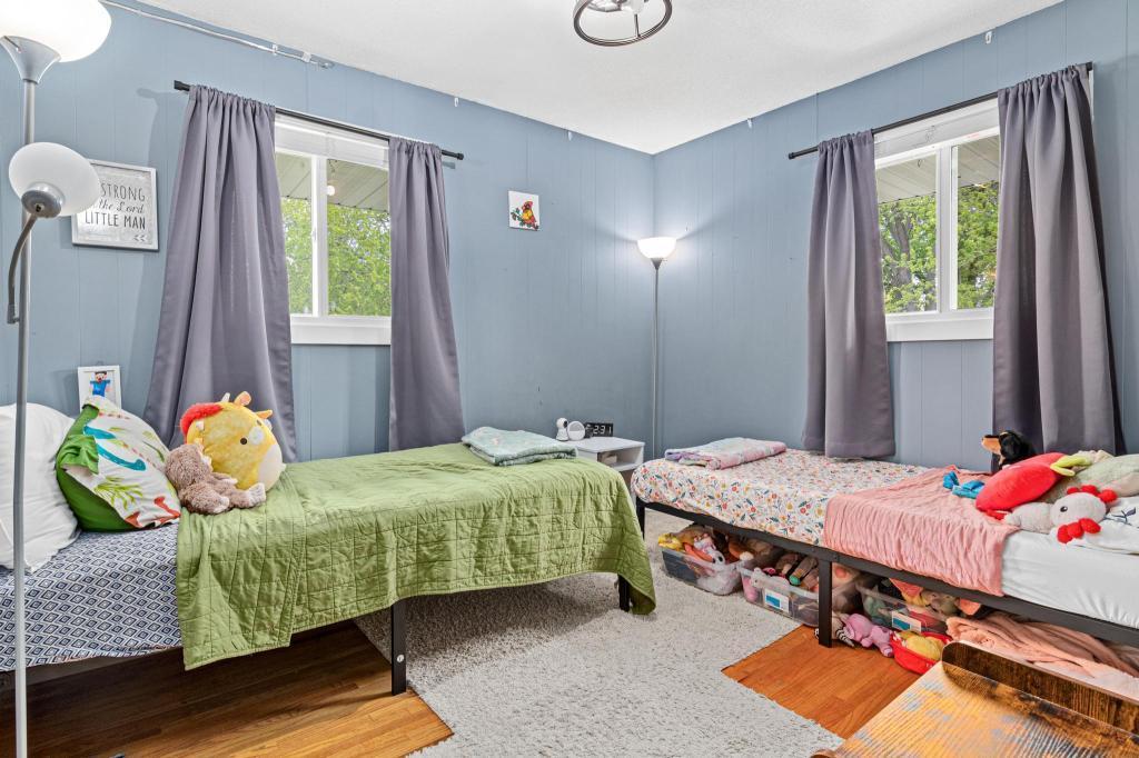 One of two main level bedrooms offering comfortable space and great natural light.