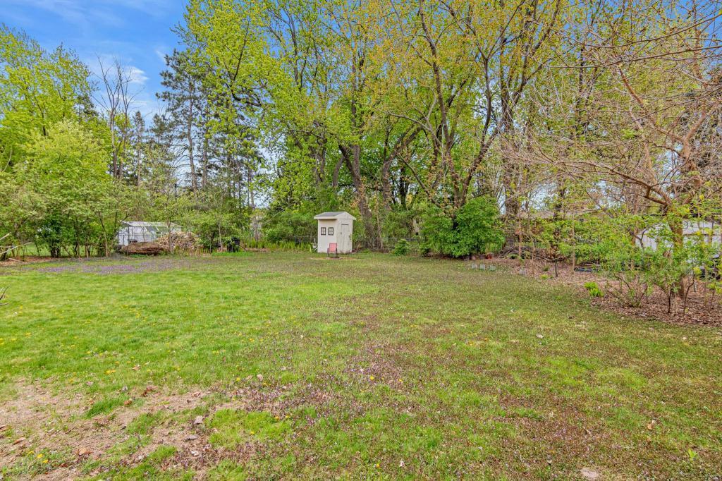 Large, flat backyard offers space to relax, garden, or entertain outdoors.