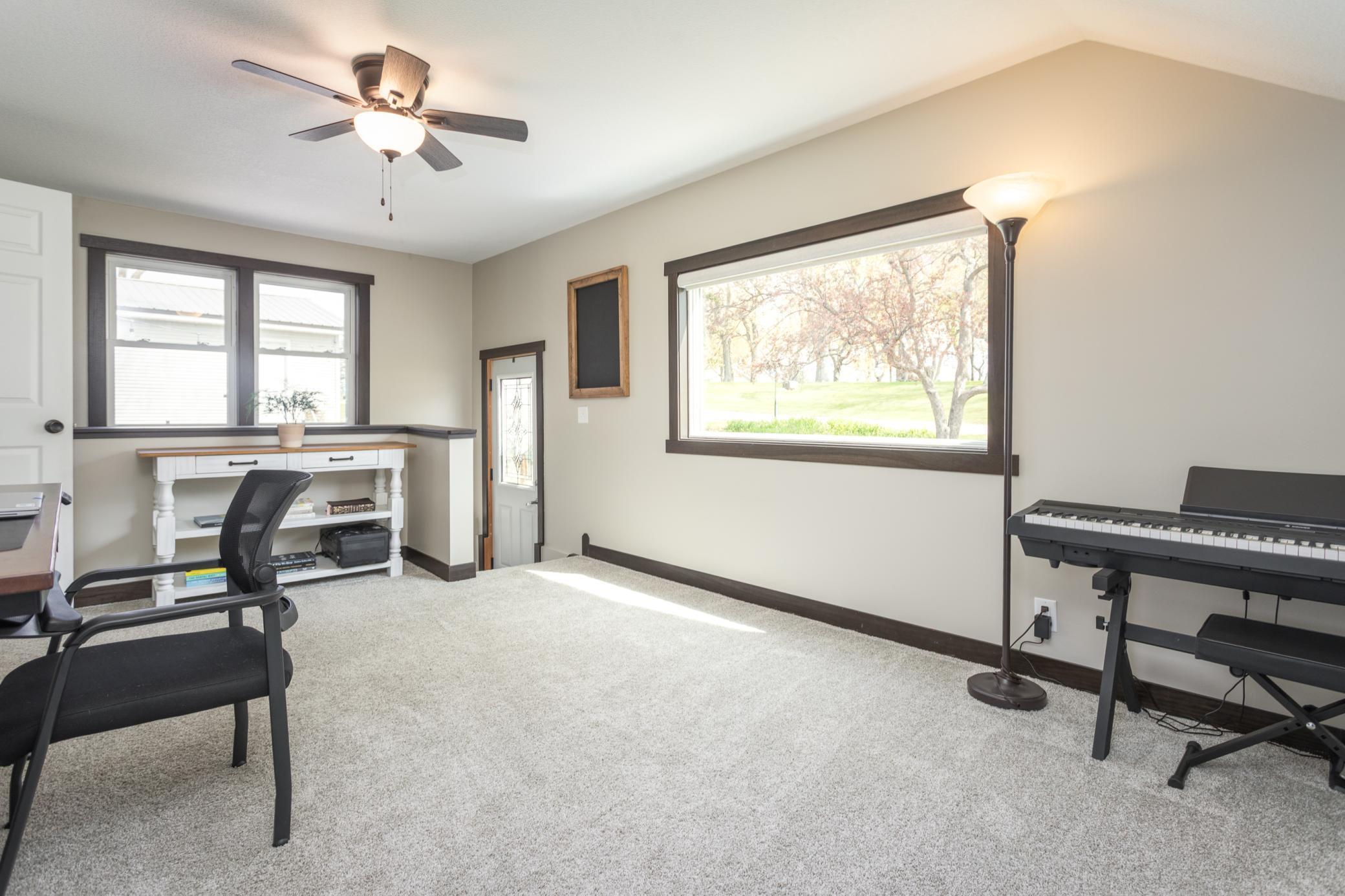 Cozy room off the entry, perfect as a versatile living area or home office.