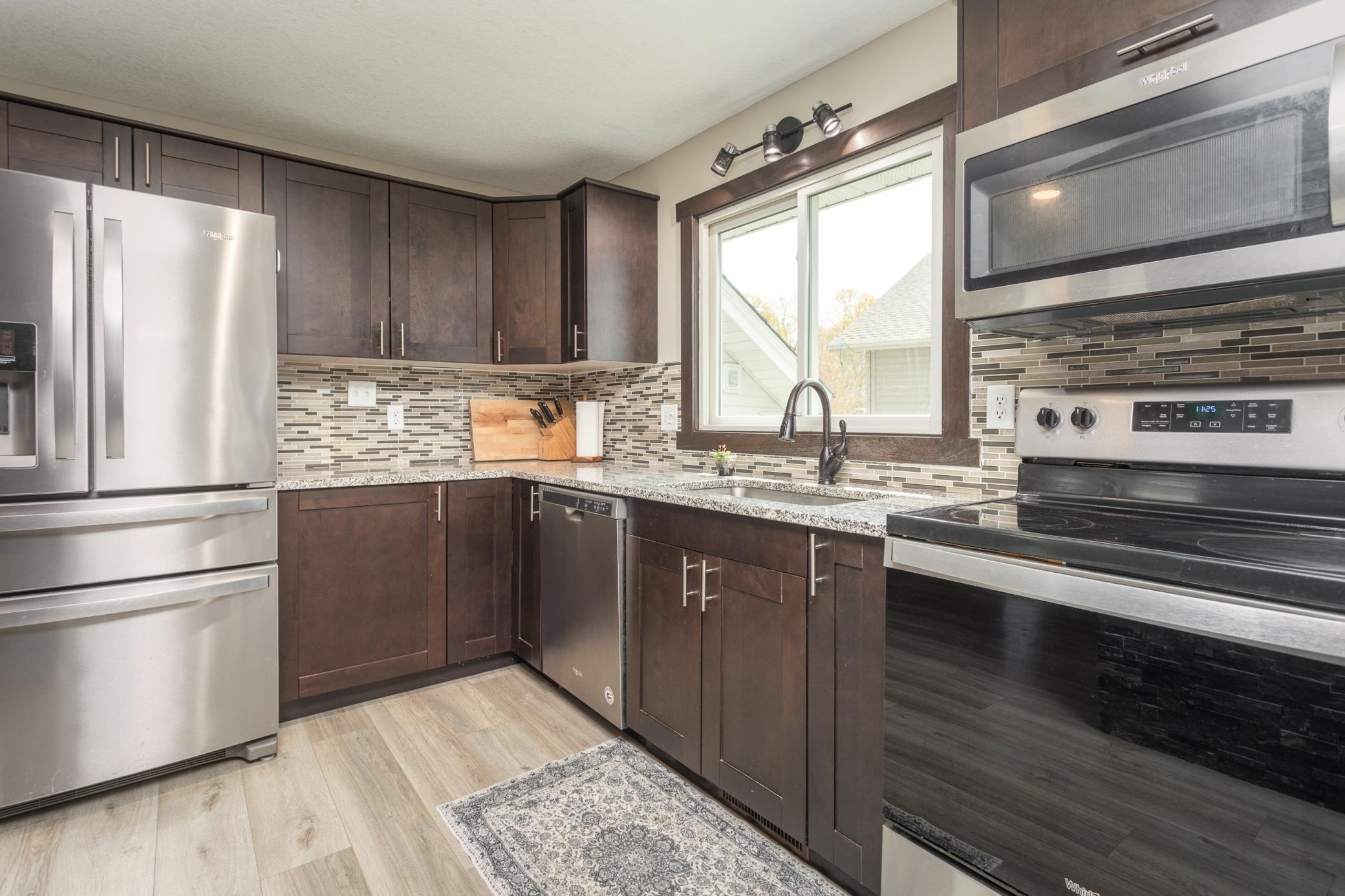 Bright, inviting kitchen with a large sunlit window.