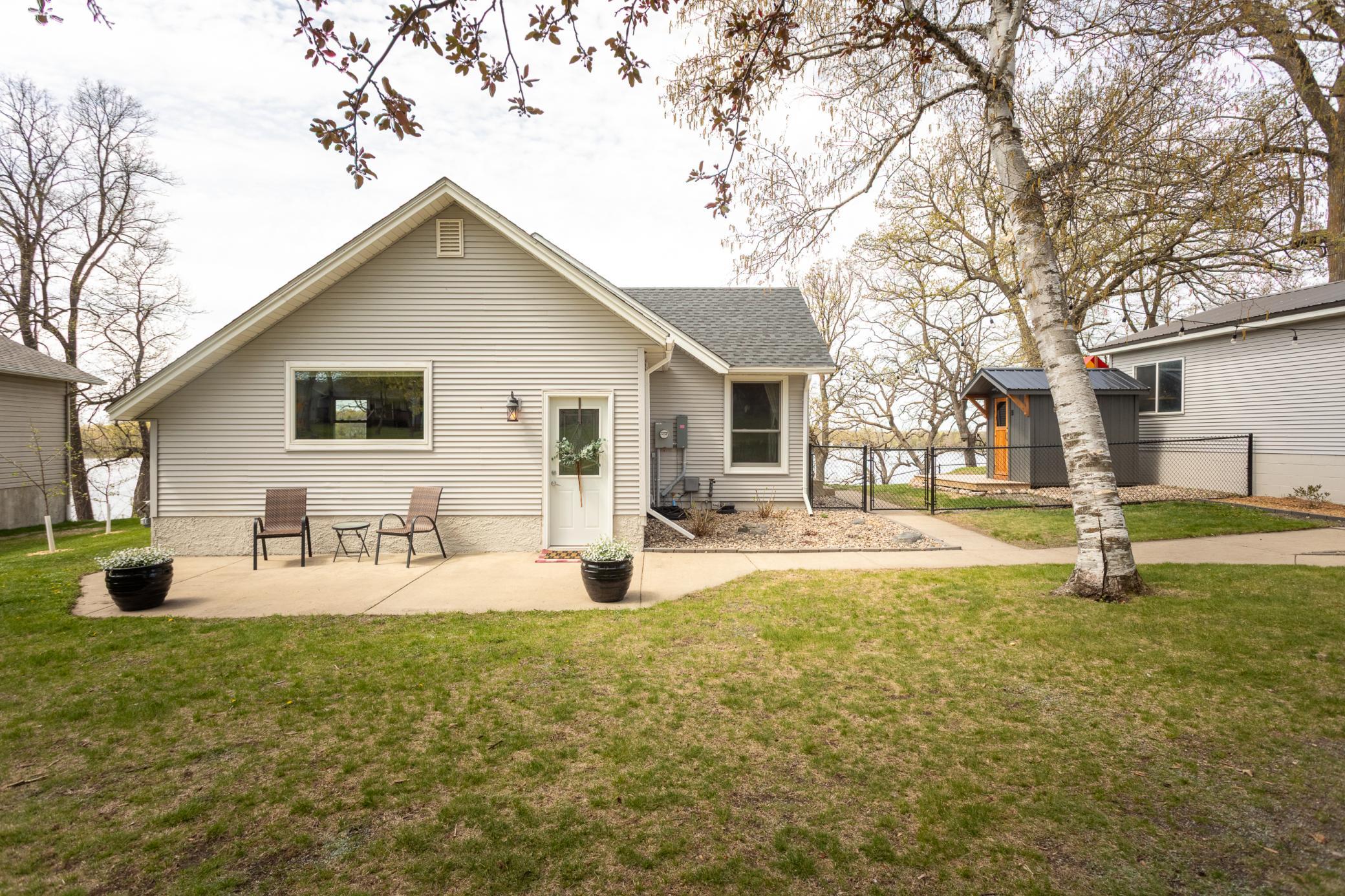 Front view of the home with a small patio, ideal for relaxing or morning coffee.