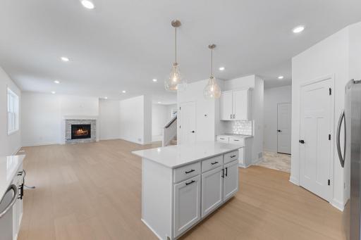(Photo of a similar home, actual finishes may vary) The center island overlooks the dining room and Great Room to promote seamless everyday living