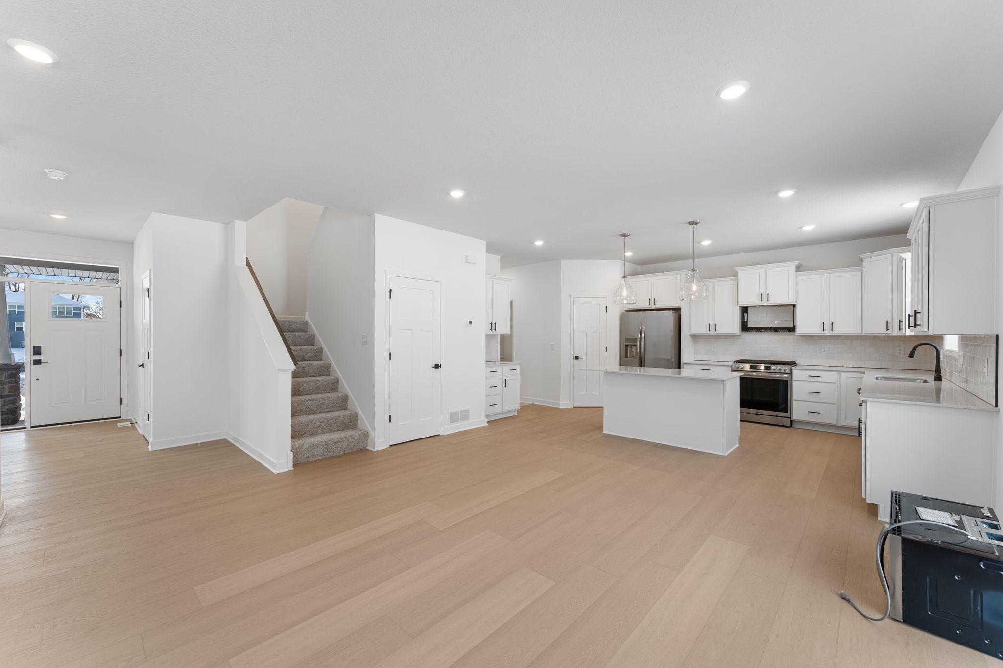 (Photo of a similar home, actual finishes may vary) Situated steps away from the kitchen, residents can effortlessly serve piping-hot meals straight off the stove and onto the dining table with ease.