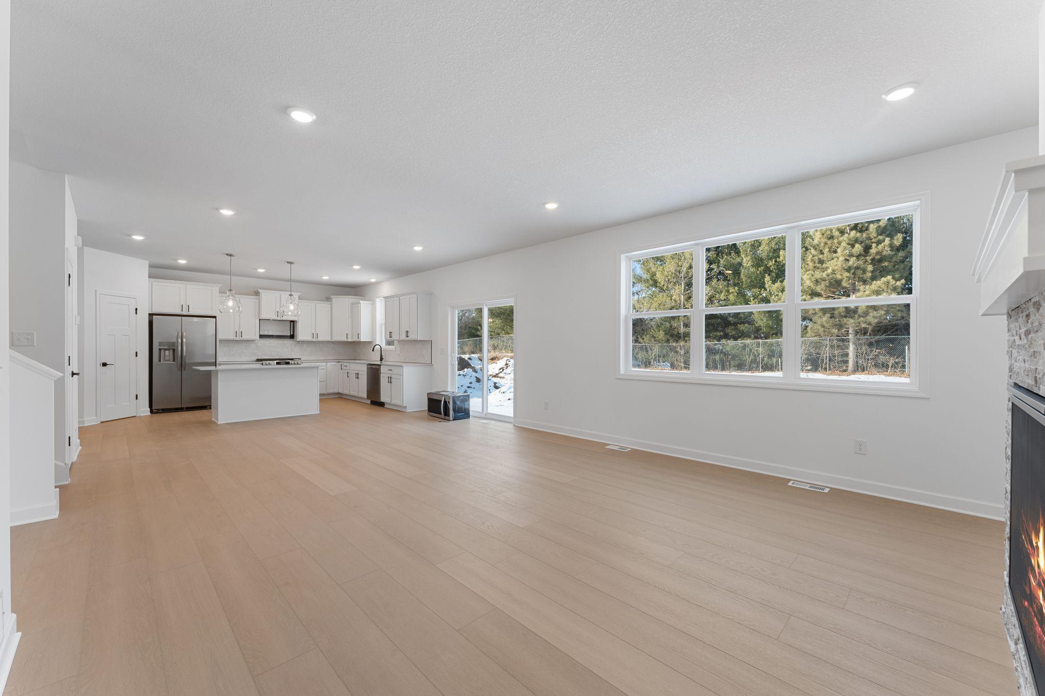 (Photo of a similar home, actual finishes may vary) The center island overlooks the dining room and Great Room to promote seamless everyday living