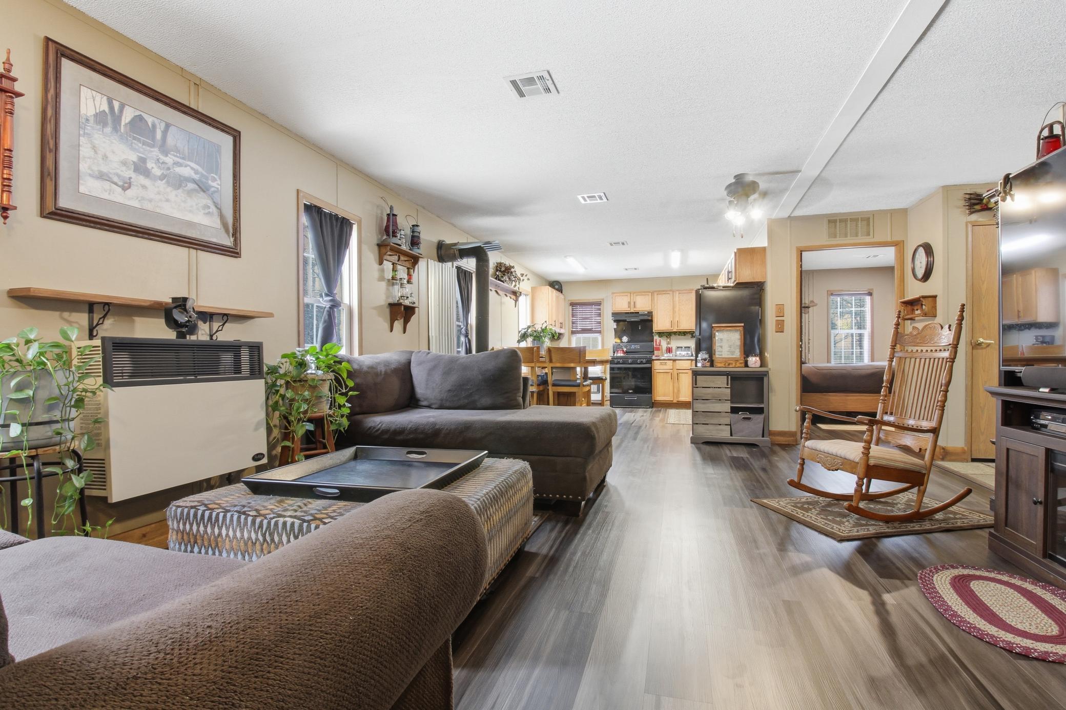 Spacious open-concept living area flows into the dining and kitchen space, creating a comfortable gathering place for everyday living