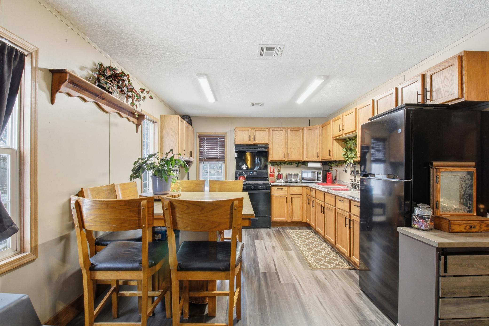 Spacious kitchen with ample cabinet storage and a comfortable dining area, perfect for gathering after a day enjoying nearby Mille Lacs Lake.