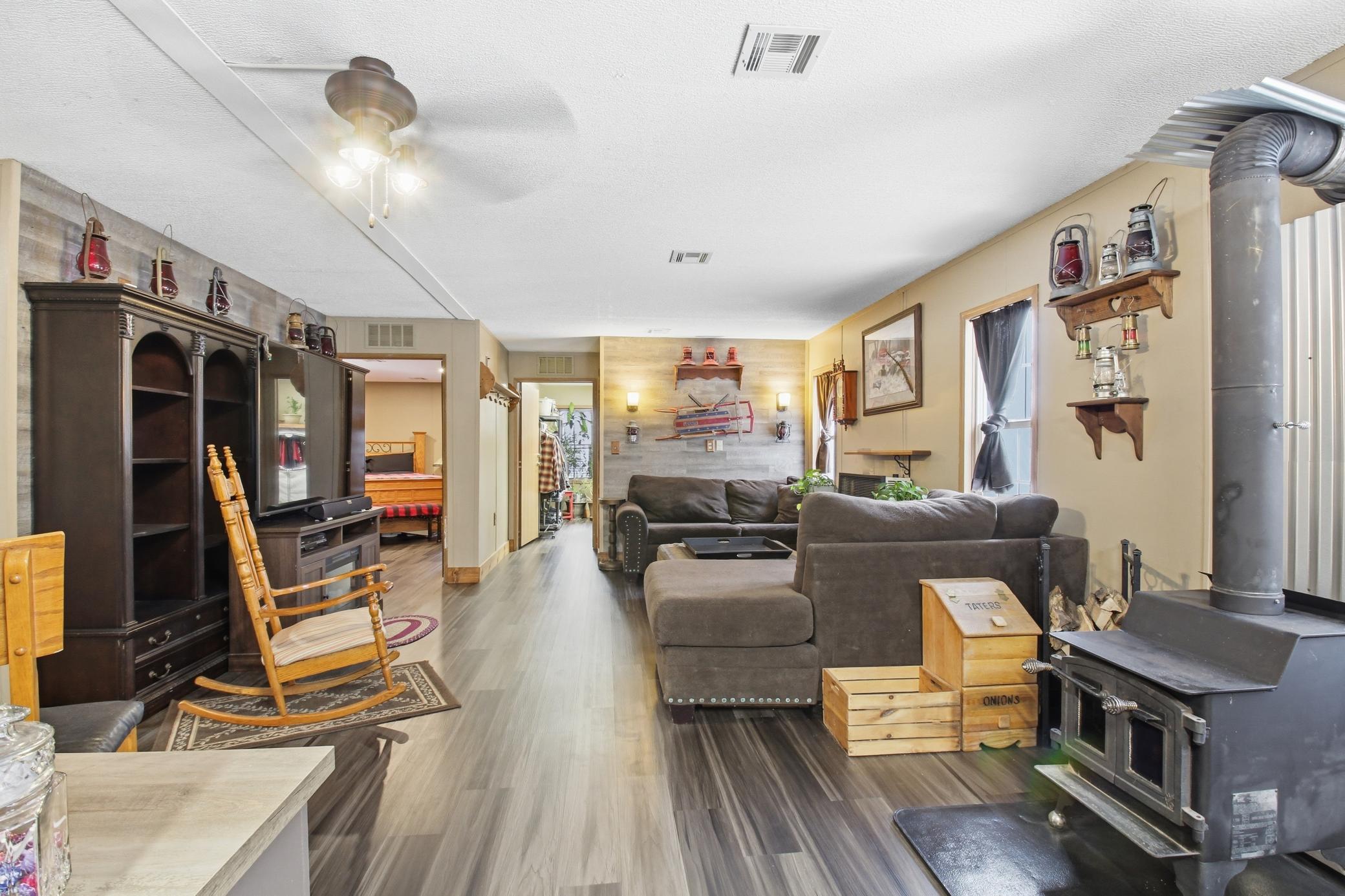 Open living area with cozy wood stove and an easy flow toward the bedrooms.