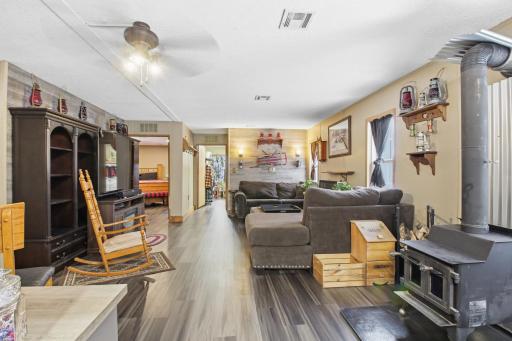 Open living area with cozy wood stove and an easy flow toward the bedrooms.
