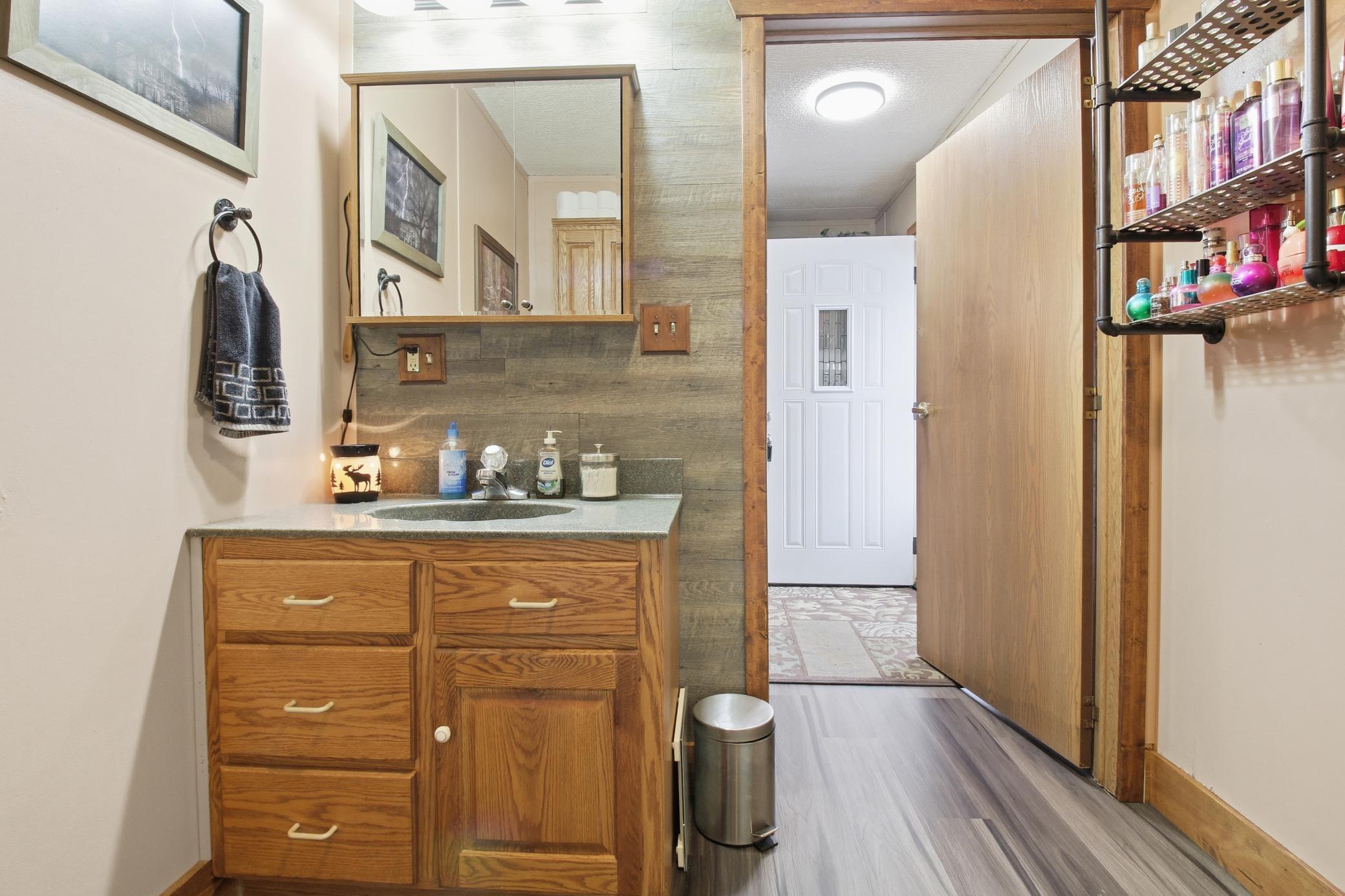 Bathroom vanity area with additional counter space and storage.