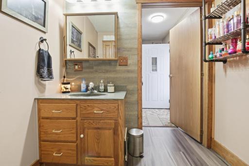 Bathroom vanity area with additional counter space and storage.
