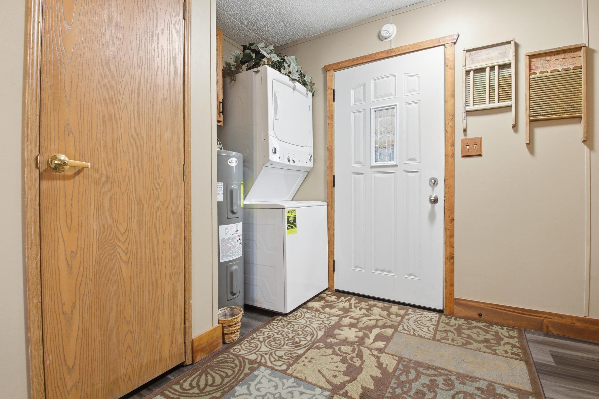 Entry area with stacked washer and dryer for convenient laundry access.