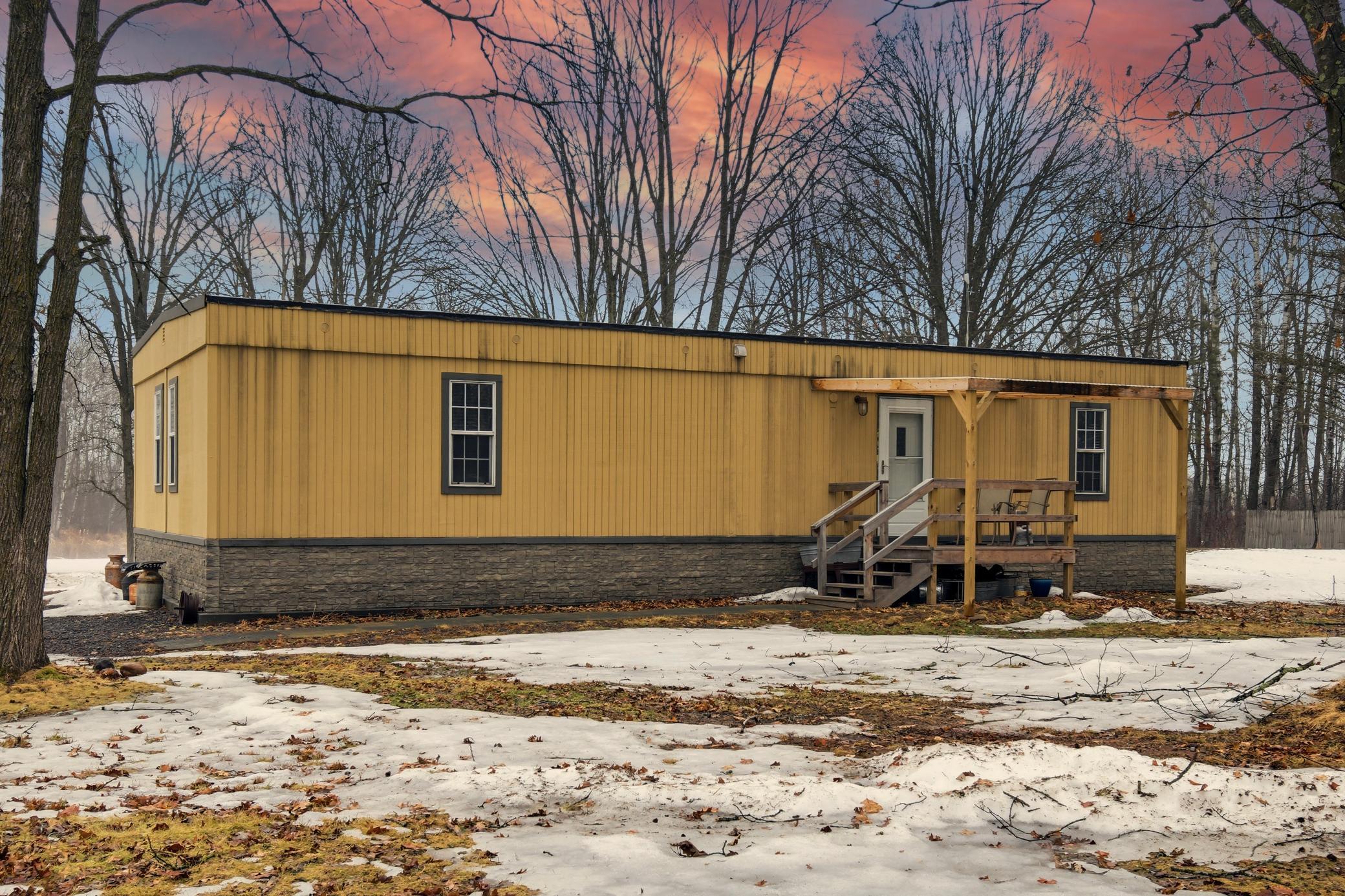 Tucked into the woods on 5 acres, this property offers the perfect mix of privacy and outdoor recreation
