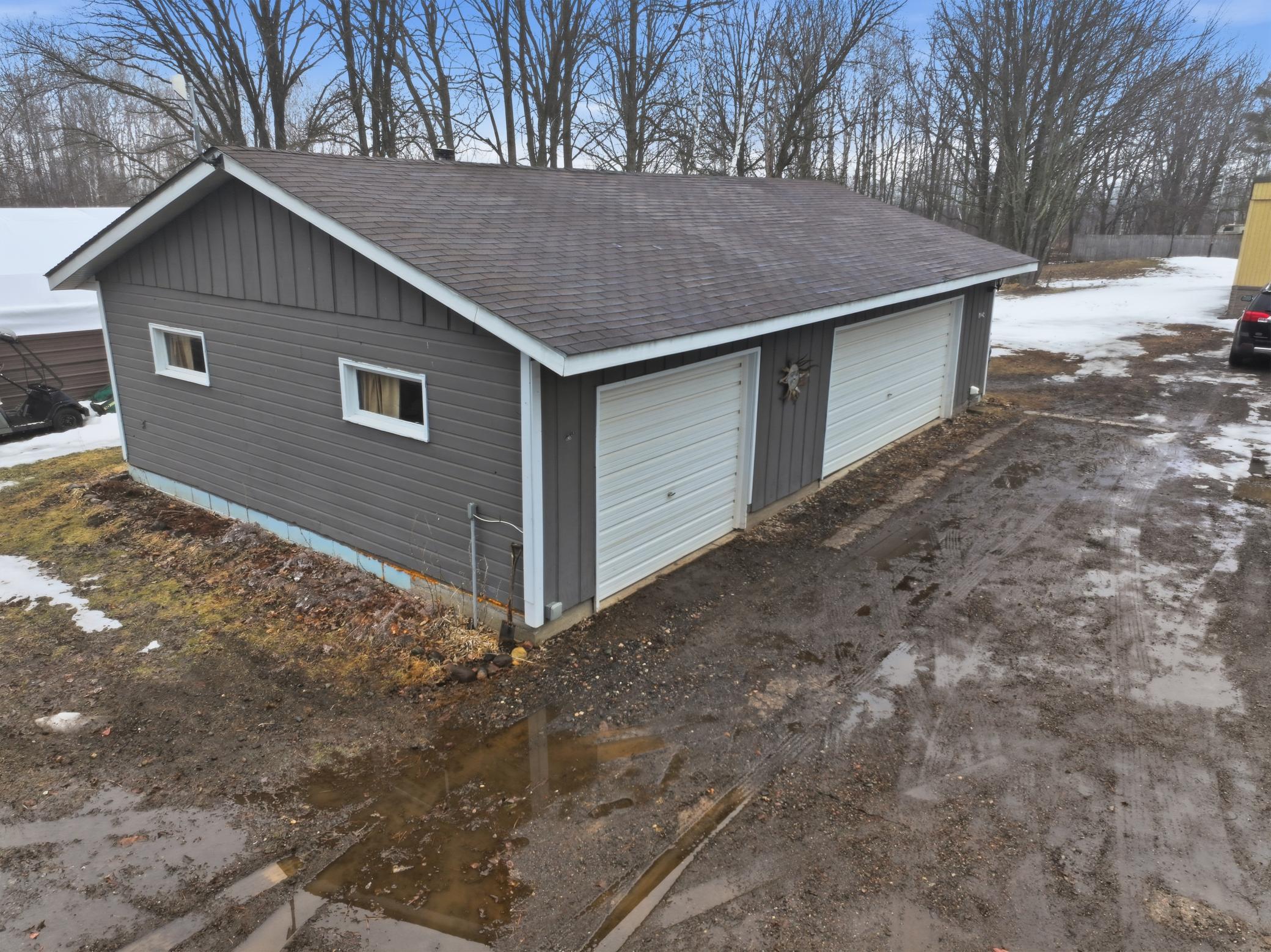 Large detached three-stall garage with easy access and space for vehicles or hobbies