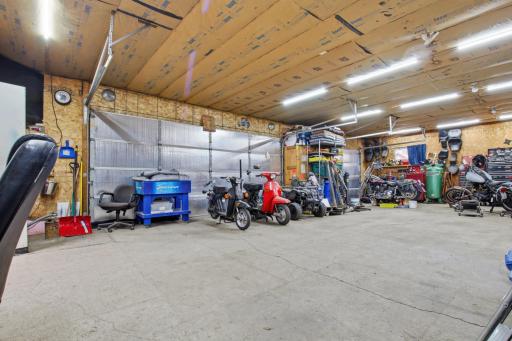 Expansive garage interior with room for vehicles, recreational toys, and workshop space