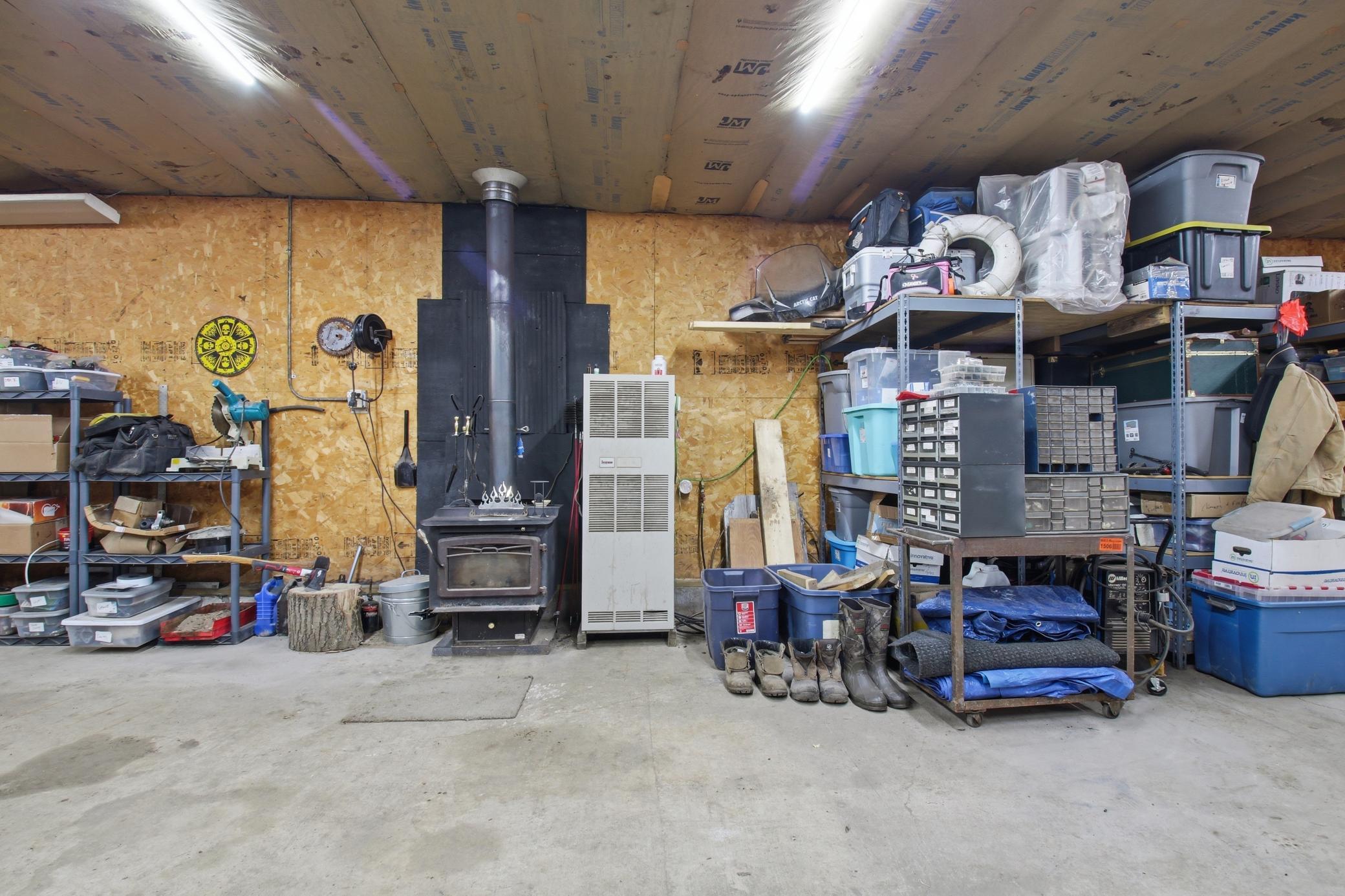 Garage workshop area with storage and heating options for year-round use.