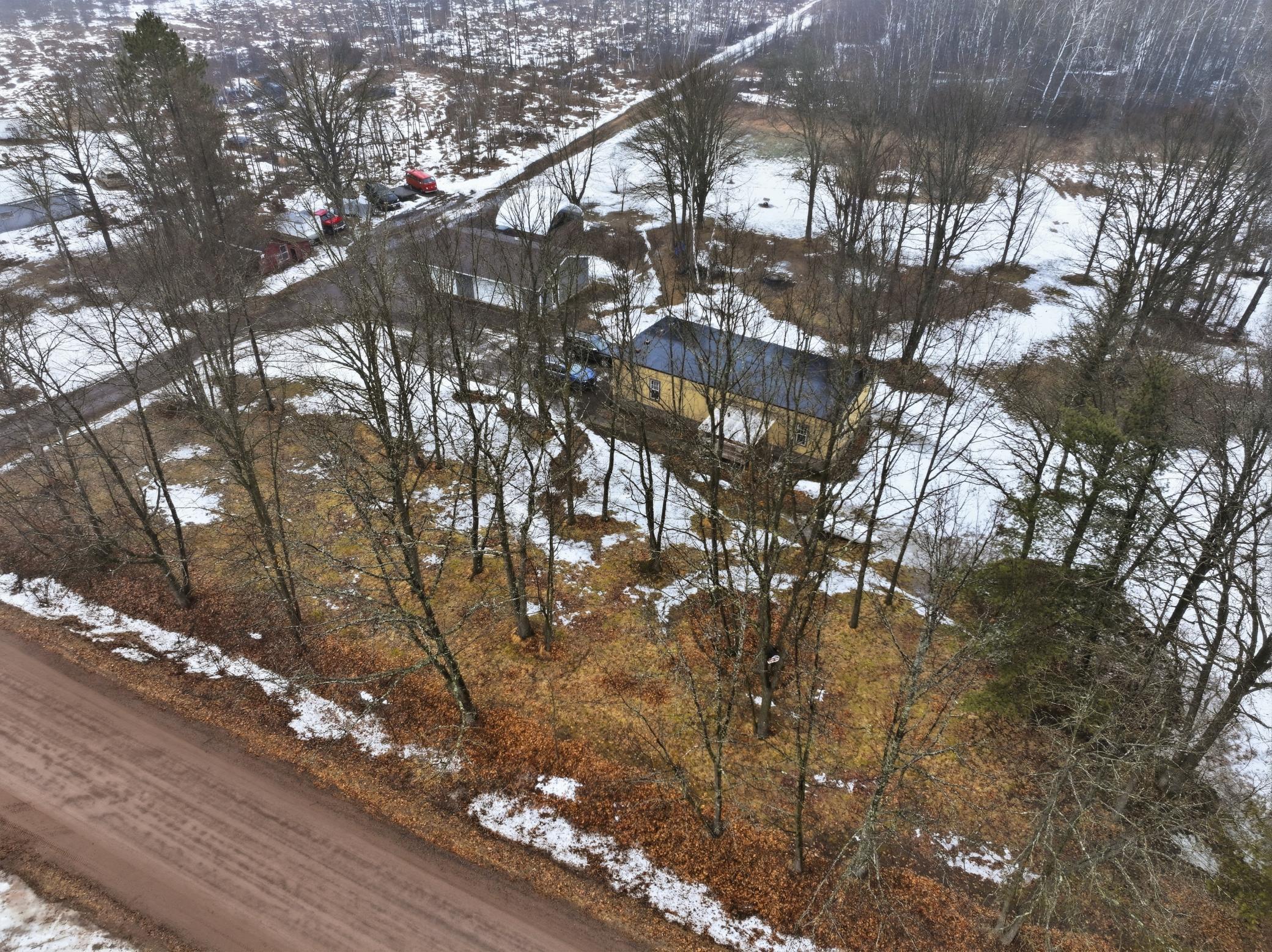 Aerial view highlighting the home’s private setting surrounded by mature trees.”