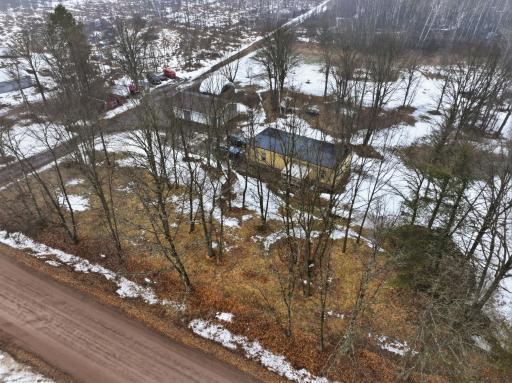 Aerial view highlighting the homeâs private setting surrounded by mature trees.â