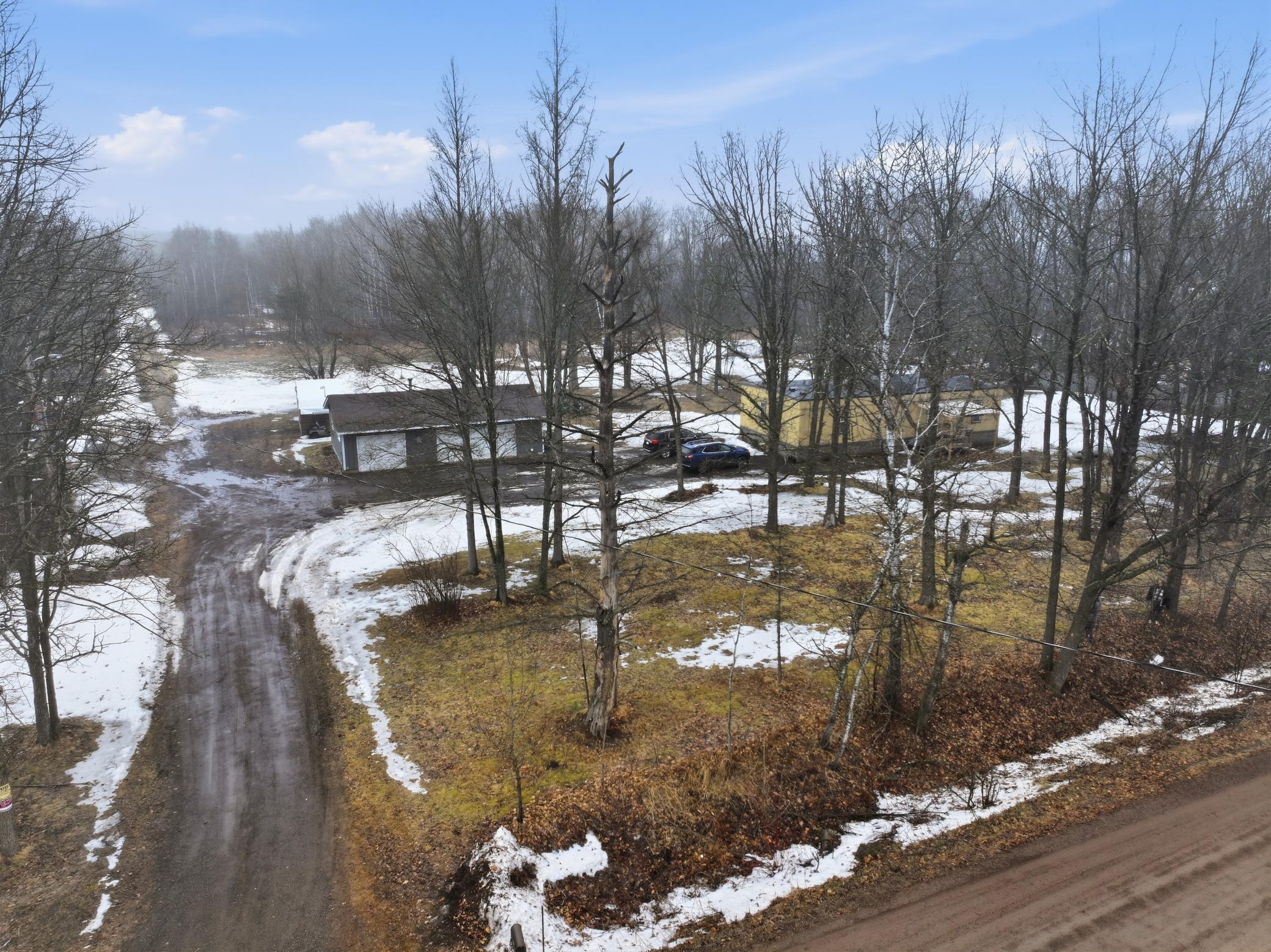 “Aerial view showing the home, detached garage, and curved driveway entrance..jpg