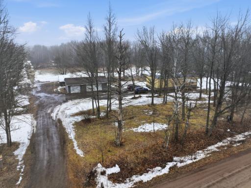 âAerial view showing the home, detached garage, and curved driveway entrance..jpg