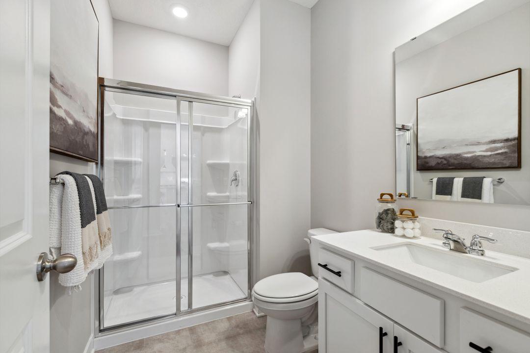 The main level 3/4 bath is located right off the owner's entry and main level bedroom - conveniently located for the entire household. Photo of a model home, color & options will vary.