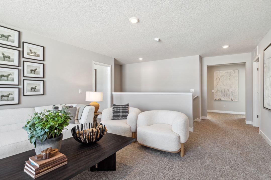 Once upstairs, the entire level flows from the focal point offered by this huge loft space. Sure to become a family favorite hangout spot! Photo of a model home, color & options will vary.