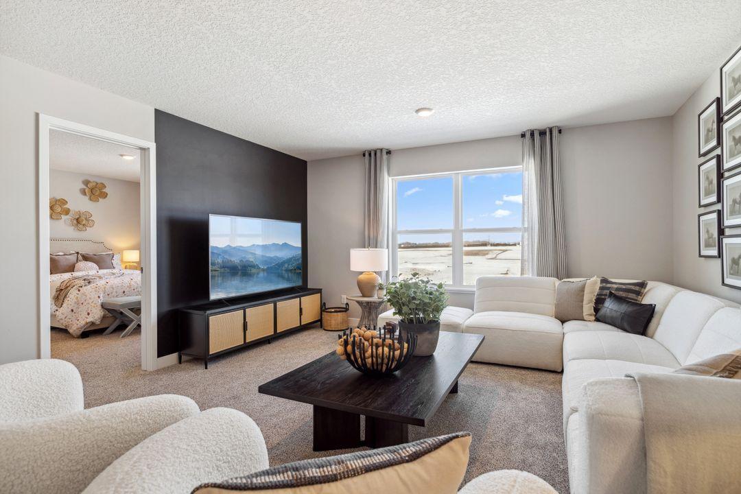 Once upstairs, the entire level flows from the focal point offered by this huge loft space. Sure to become a family favorite hangout spot! Photo of a model home, color & options will vary.