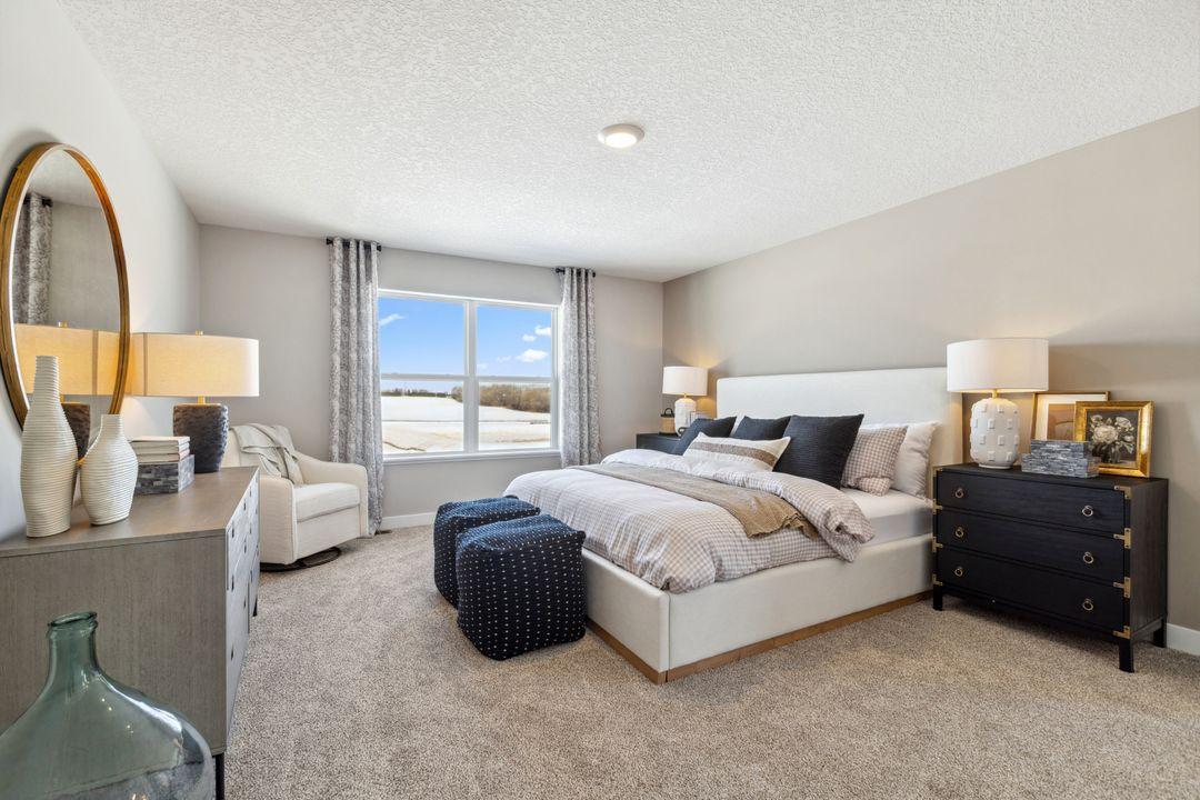 An oasis of its own, the primary suite offers the perfect escape. Windows will overlook the backyard, and there's immediate access to a private bathroom that features TWO walk-in closets!! Photo of a model home, color & options will vary.