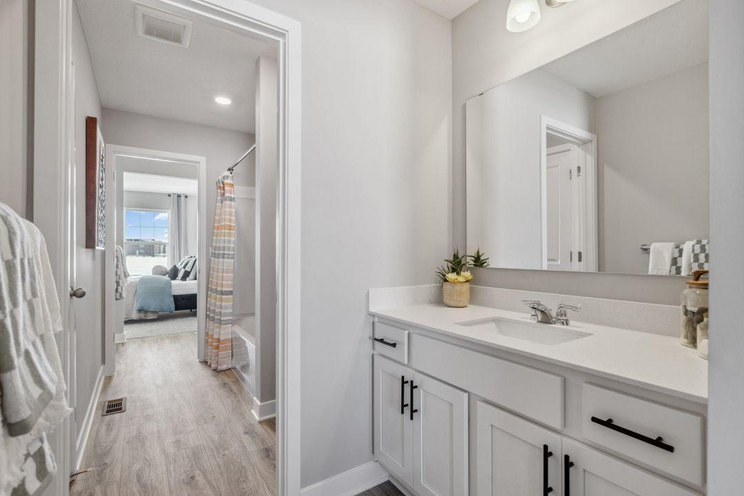 Jack and Jill bathroom with sinks for each individual bedroom. Only area shared is the shower/bath and toilet room. Photo of a model home, color & options will vary.