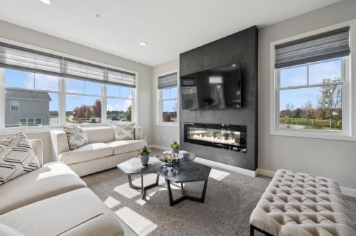 (Photo of a decorated model, actual features will vary) The family room features a stunning electric fireplace.