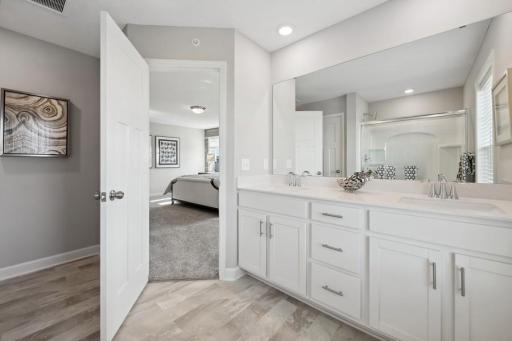 (Photo of a decorated model, actual features will vary) An extension of the owner's suite, this private and spacious bath includes a double-vanity and a large shower.