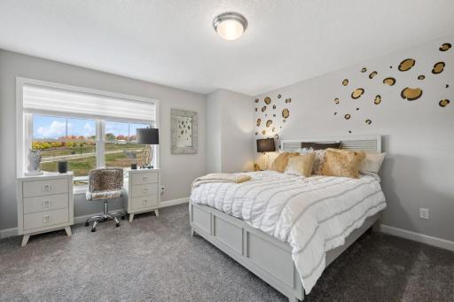One of two spacious secondary bedrooms. (Photo of a decorated model, actual features will vary)