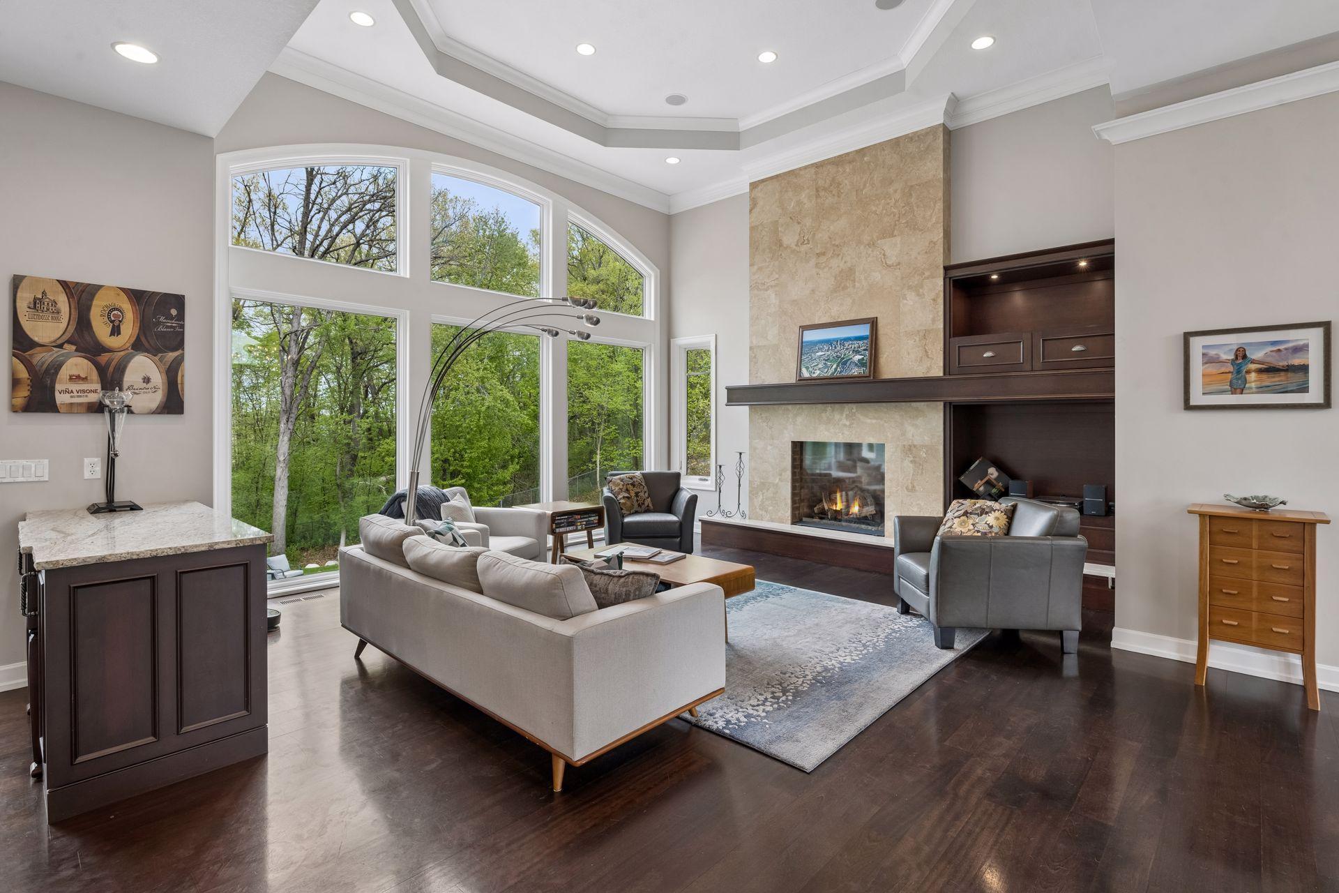 The great room boasts Brazilian cherry flooring, a travertine fireplace surround, gorgeous lighted built-ins and more.