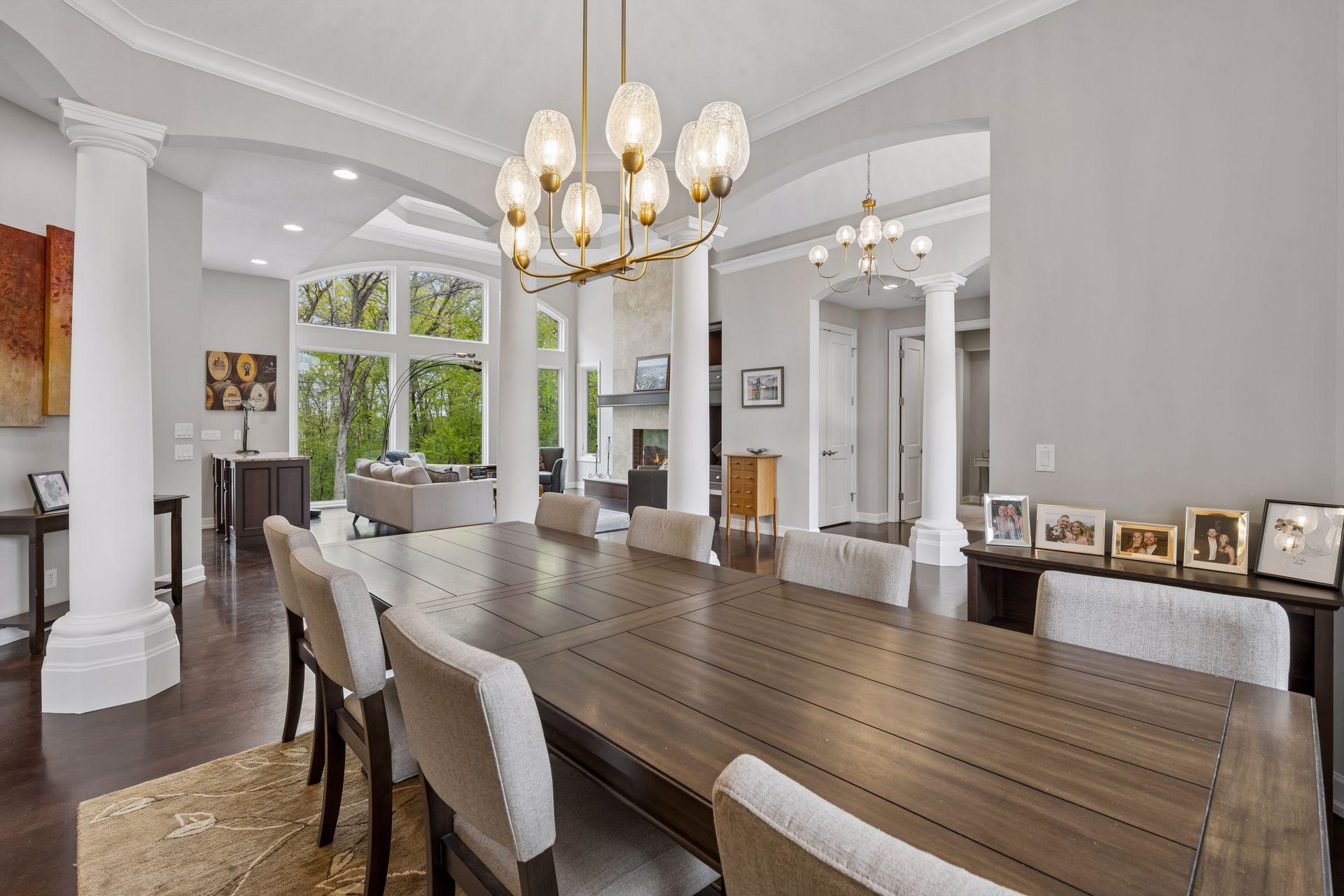 With ten-foot ceilings throughout the main level, the open floorplan feels bright and welcoming (new interior lighting throughout in 2026). Note the lush green views through every window.