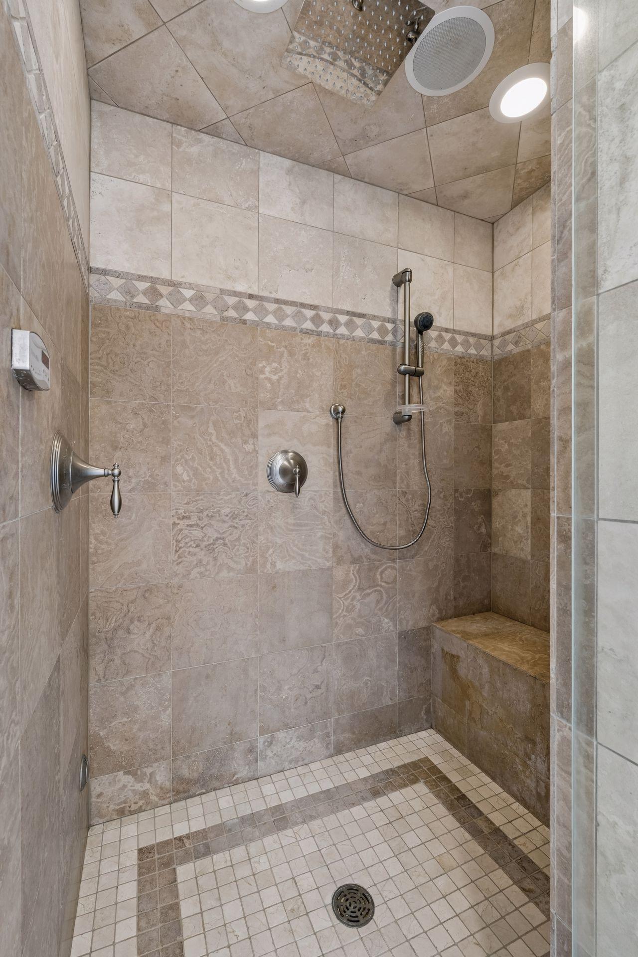A view of the steam shower in the primary bathroom. Not pictured are the TWO walk-in closets, and built in dresser.