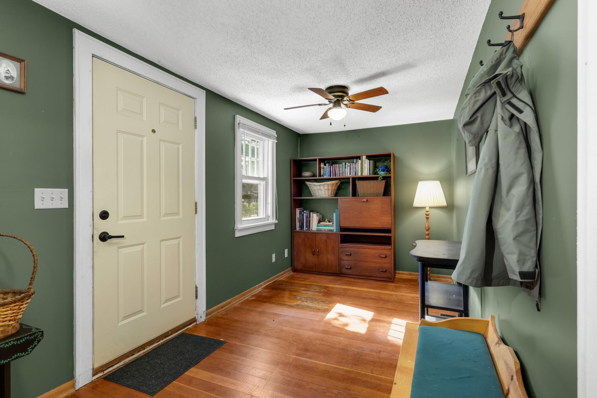 Front foyer featuring rich Douglas fir flooring, offering a warm and welcoming first impression with natural character and timeless appeal.