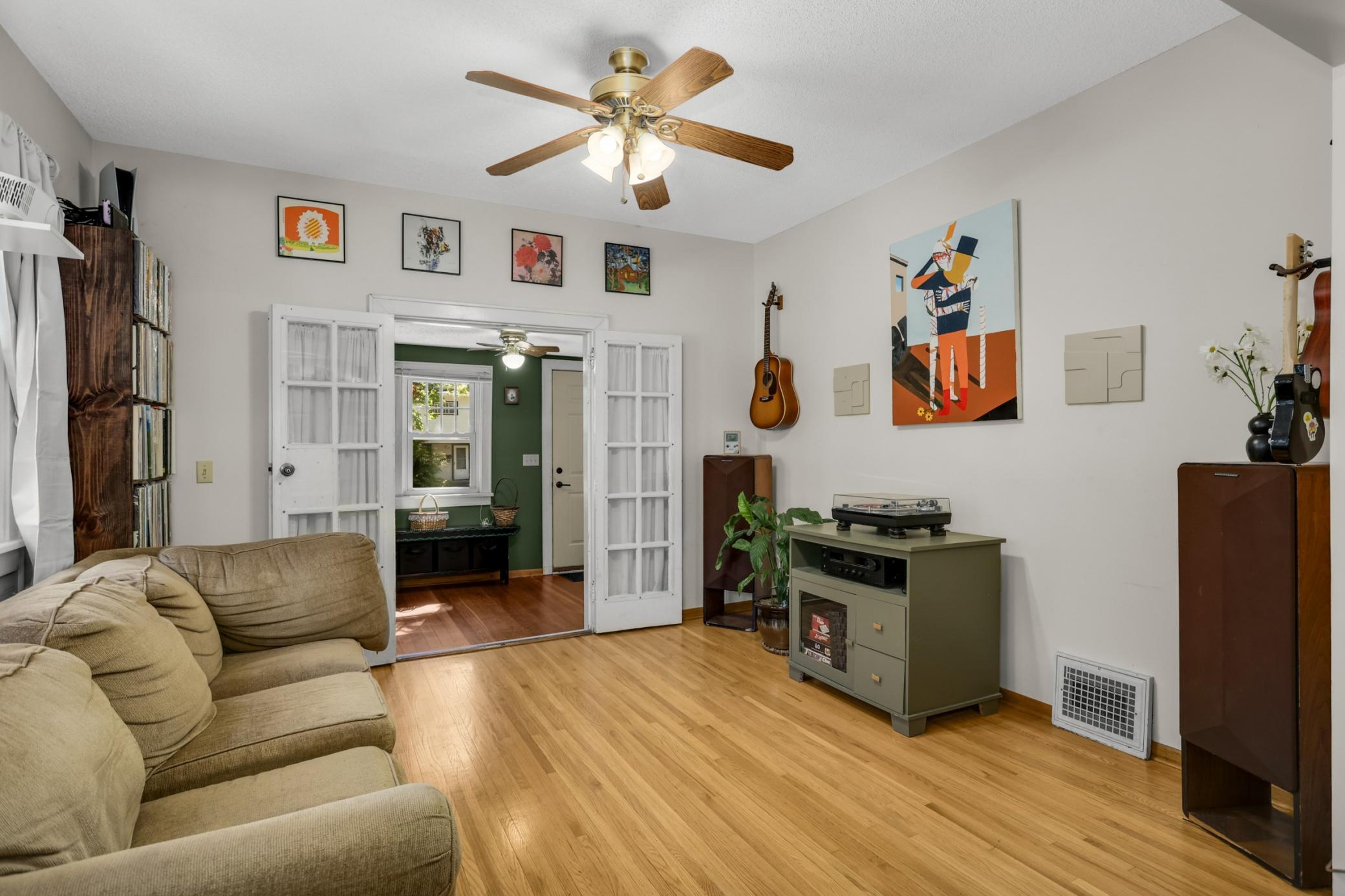 Living room featuring durable maple hardwood flooring, adding warmth, brightness, and a clean, timeless finish that enhances the overall living space.