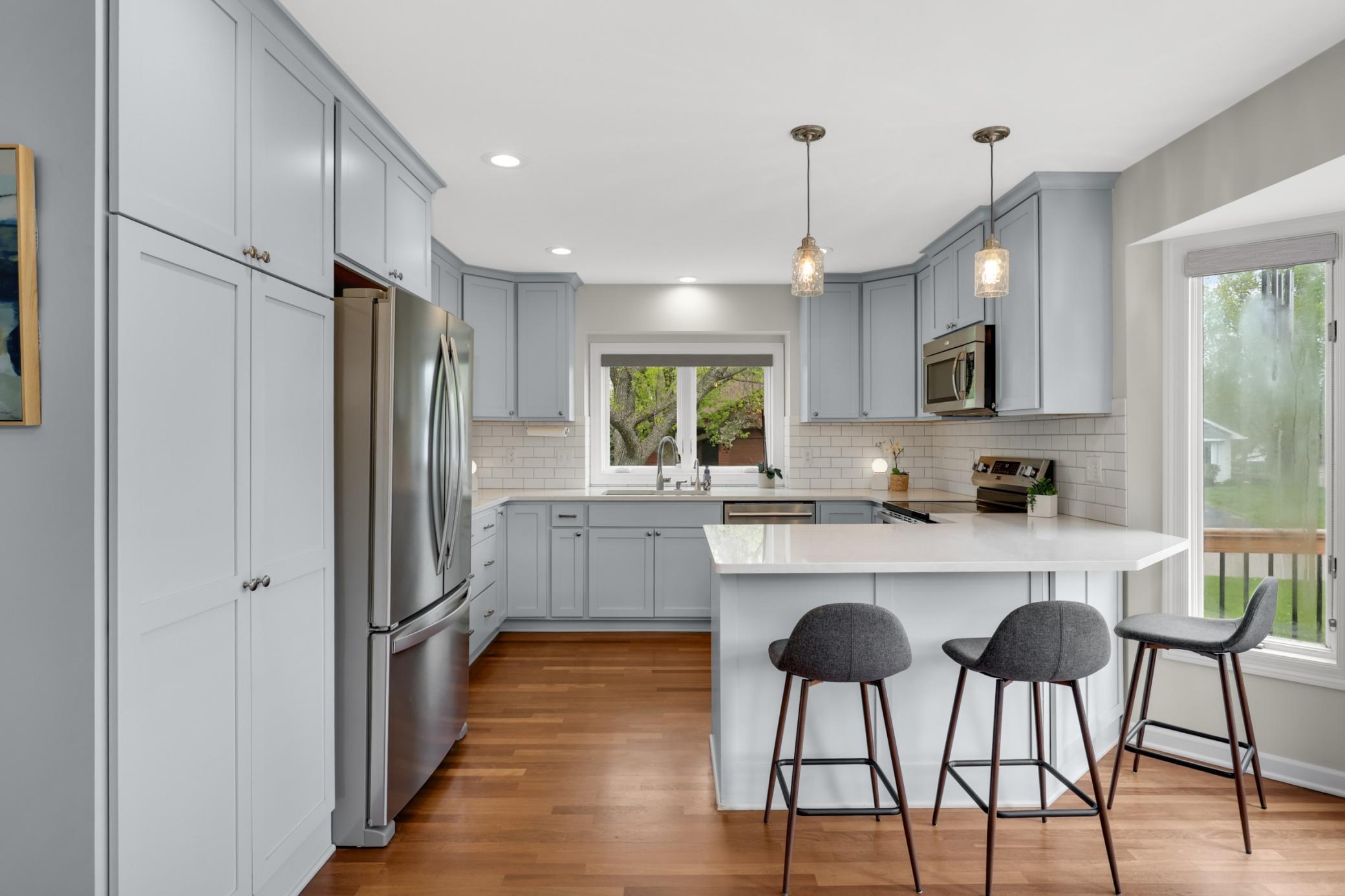 Beautifully remodeled kitchen thoughtfully opened to the dining and living rooms, creating an ideal open-concept layout for entertaining and everyday living.