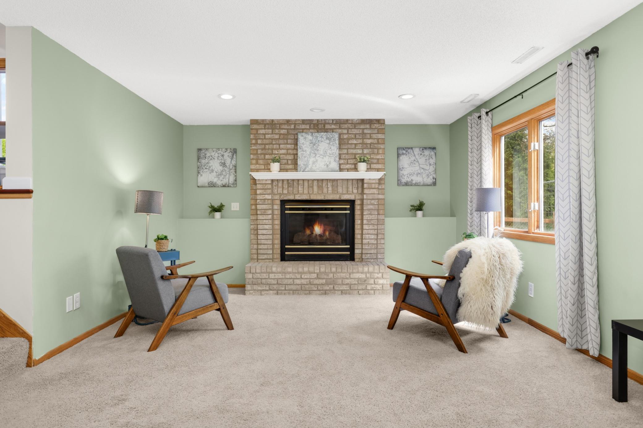 The lower-level living space offers flexibility for a family room, home office, workout area, or guest retreat.