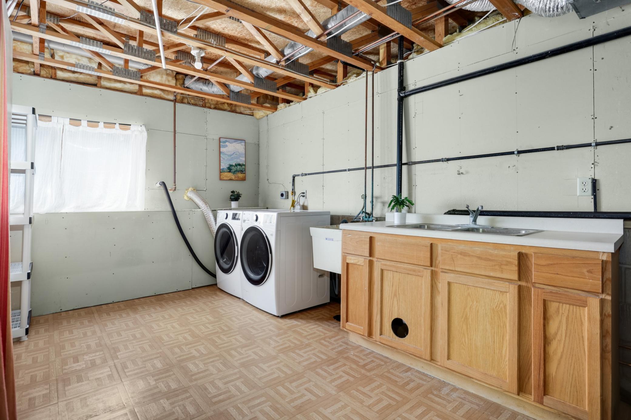Large laundry room designed for efficiency and organization, providing ample space for household tasks and extra storage.