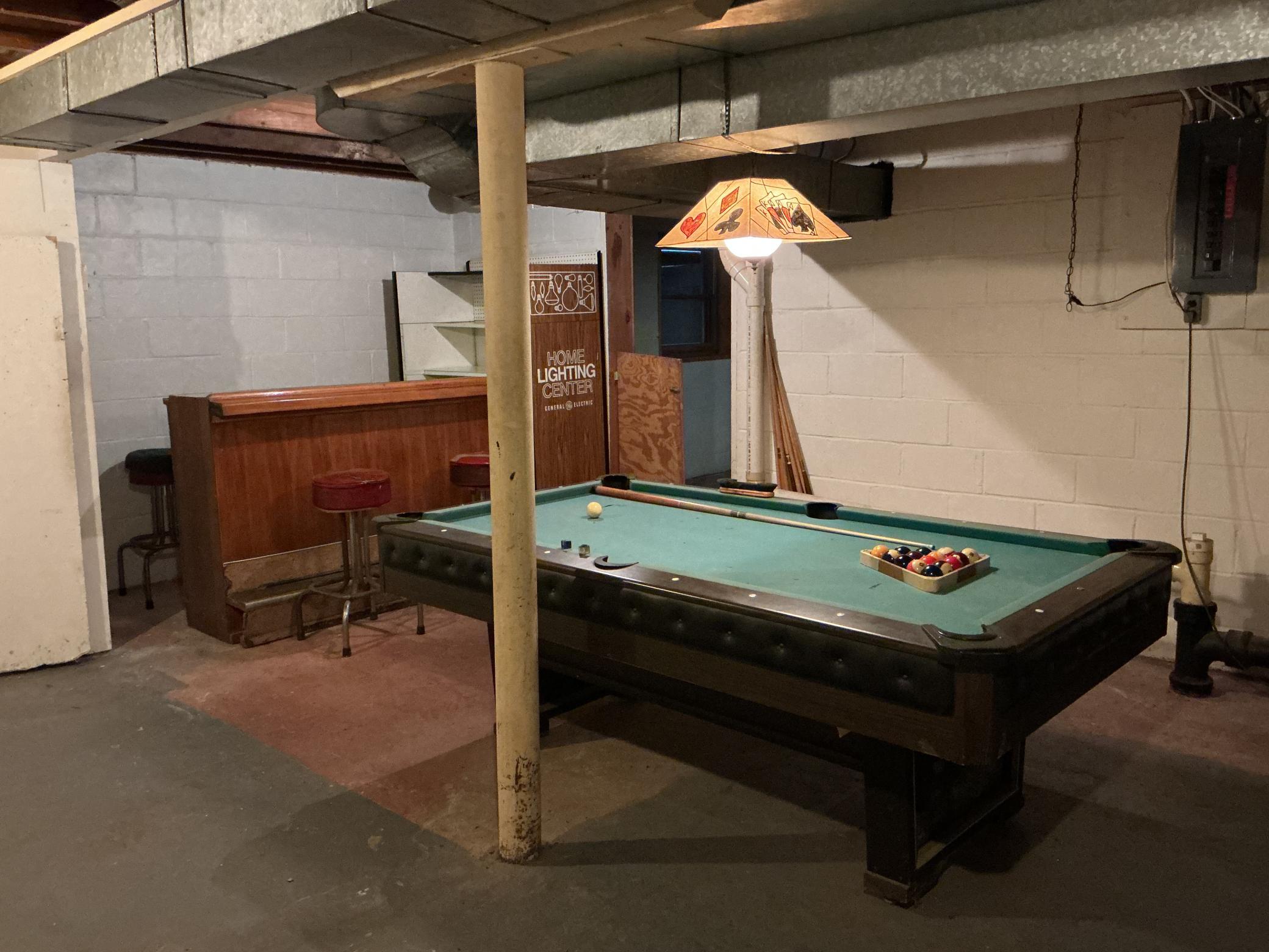 Unfinished basement currently set up for a bar/billiard area. Lots of potential. There are two very large rooms with egress windows located just on the other side of the wall.