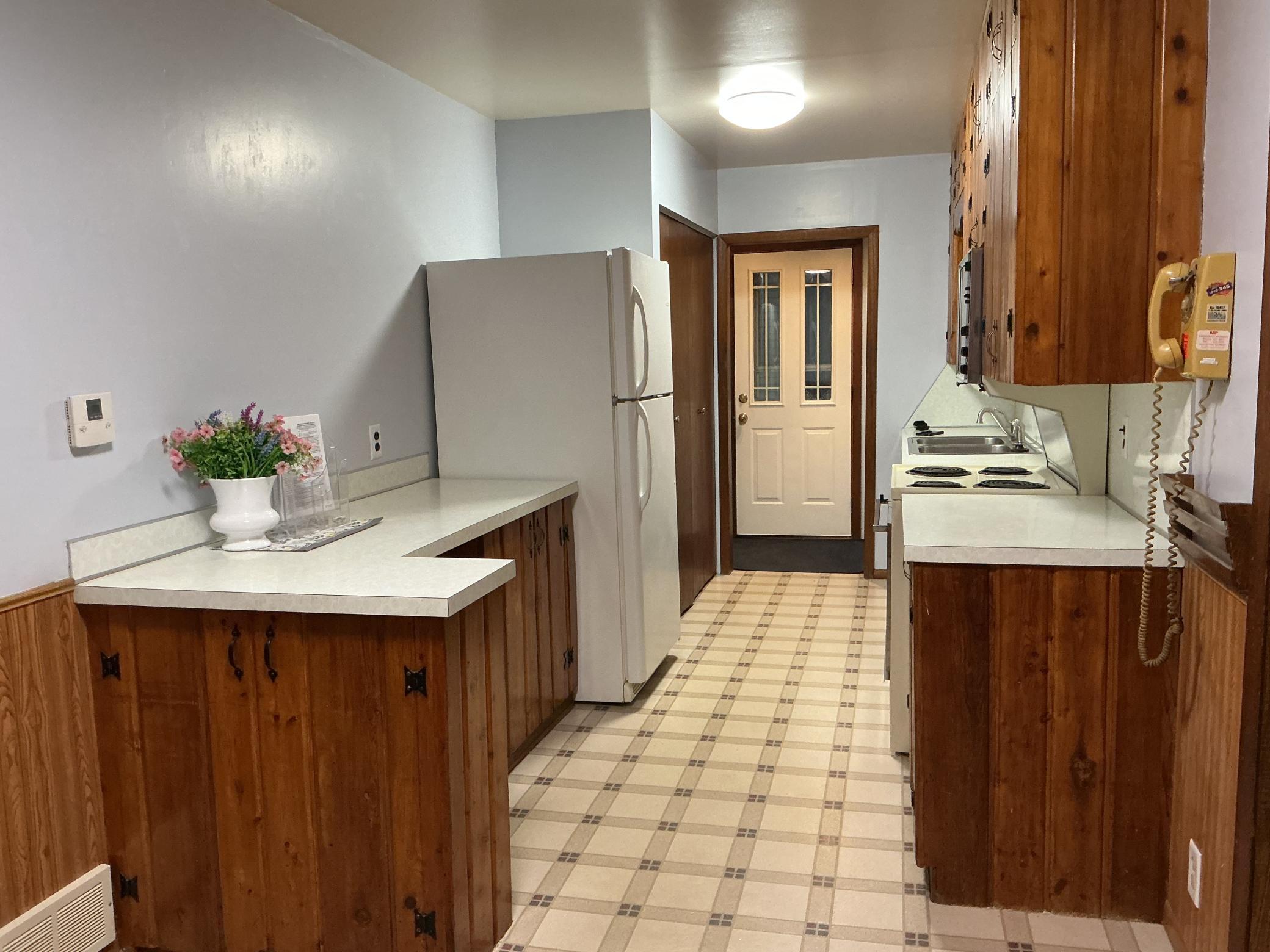 Kitchen has deep cabinets, lots of storage, good deal of counter space, and allows for visiting while you cook.
