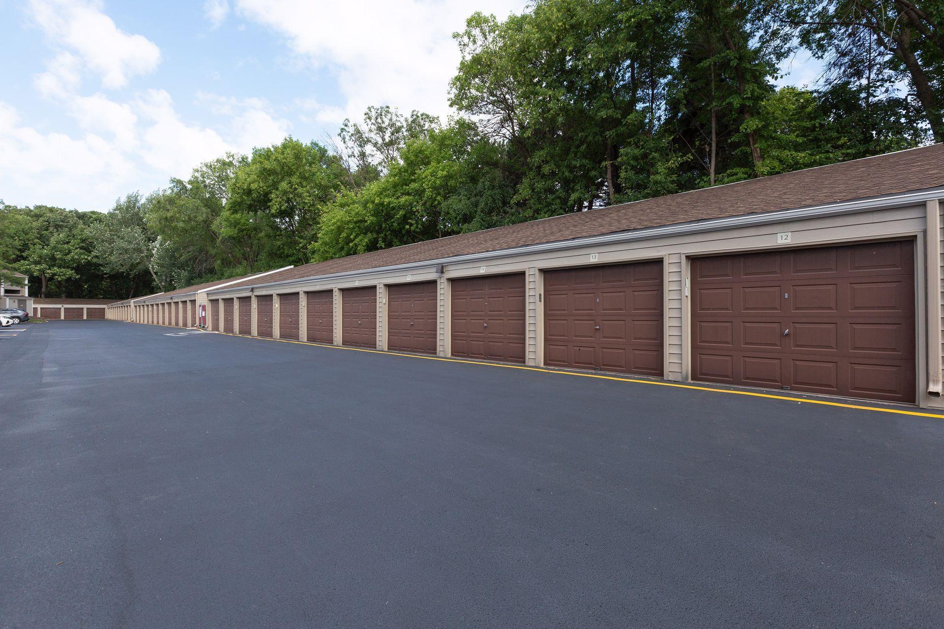 Summertime photo of parking lot and detached garages.
