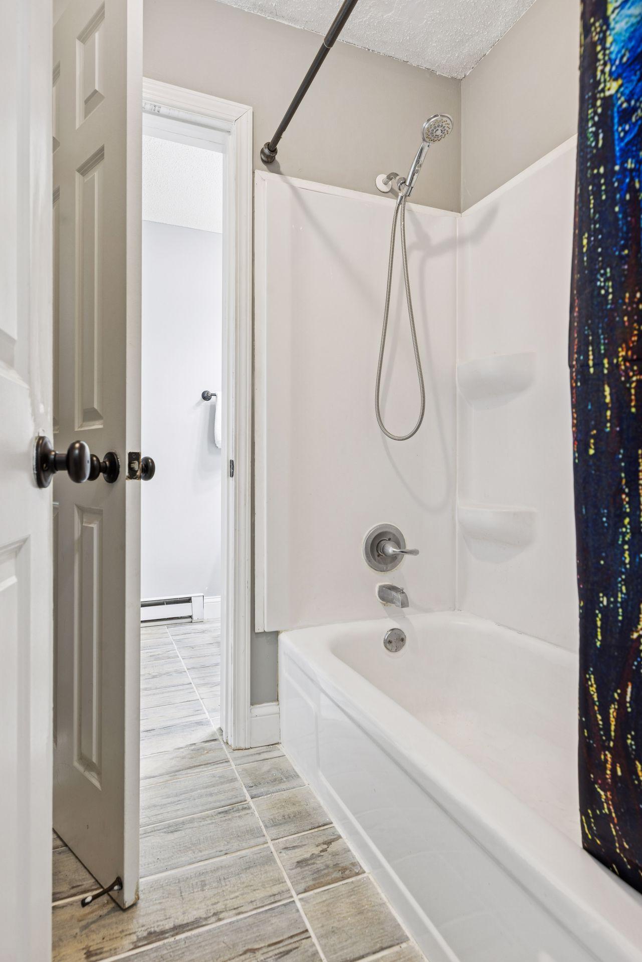 A full tub/shower located in its own enclosed space—ideal for both daily routines and guest use.