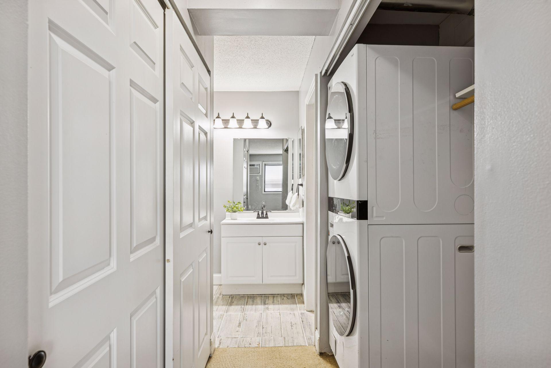 Owner's bedroom has a walk-through hallway with stacked laundry and plenty of closet space.
